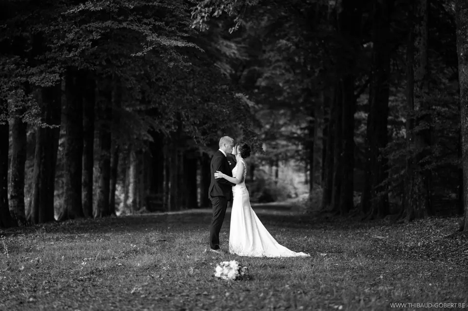 Bride and groom forehead to forehead under the trees
